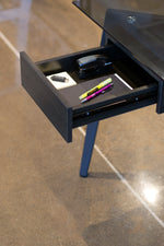 Load image into Gallery viewer, Close up of drawer in glass and metal desk.
