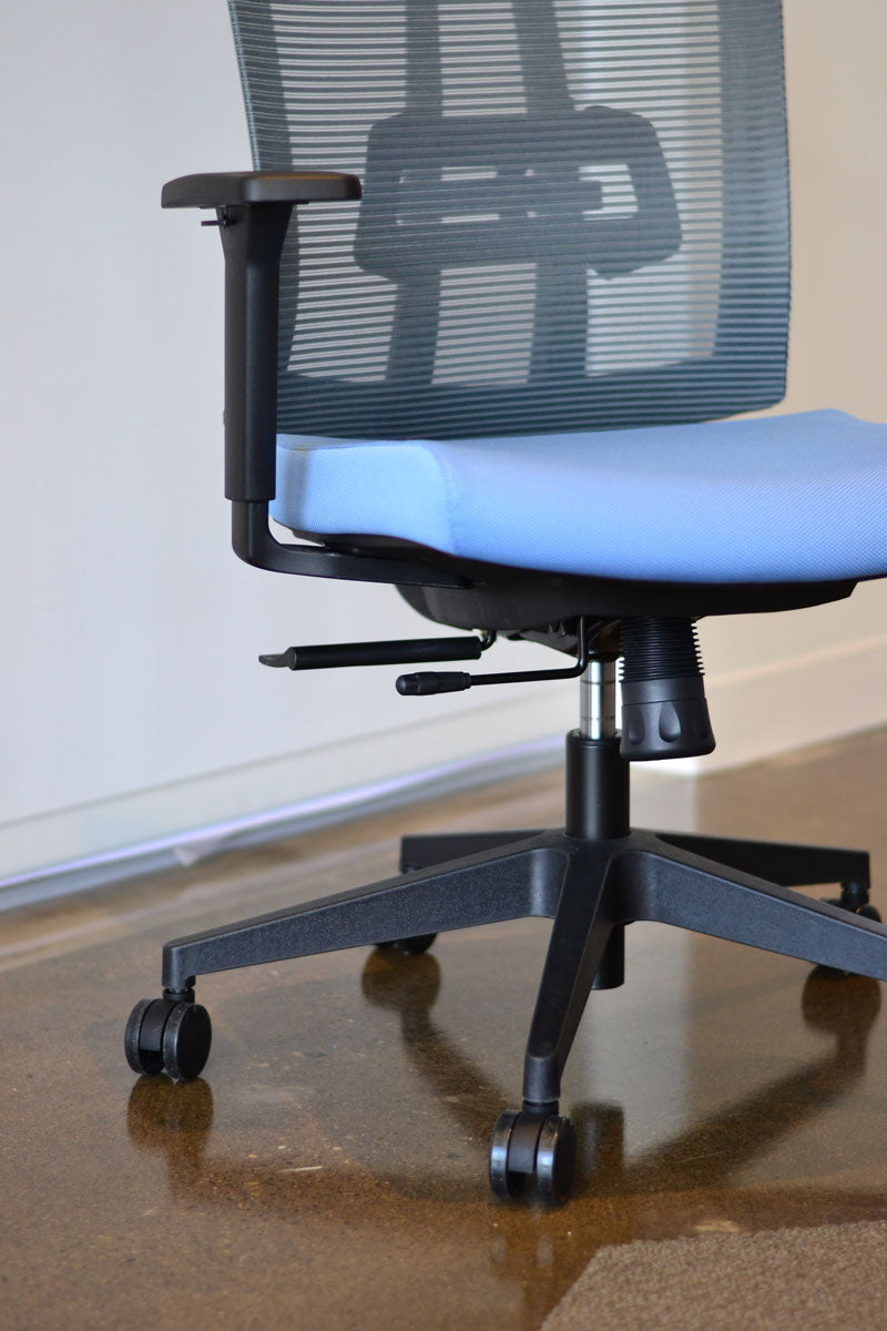 Close up view showing adjustment mechanisms for ergonomic task chair with grey mesh back and blue fabric seat.