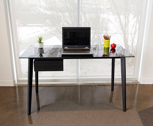 Smoke glass top desk with metal legs and black side drawer. Laptop on surface.