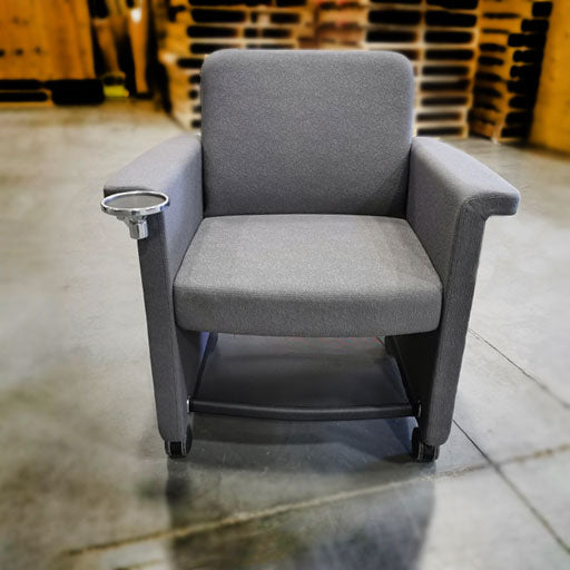 Teknion Belize lounge chair upholstered in grey fabric with cup holder and personal storage shelf